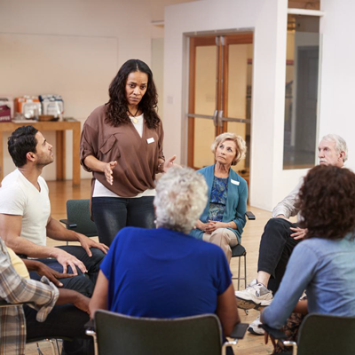 Woman standing while addressing a community meeting