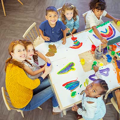 Nursery children with teacher at a table