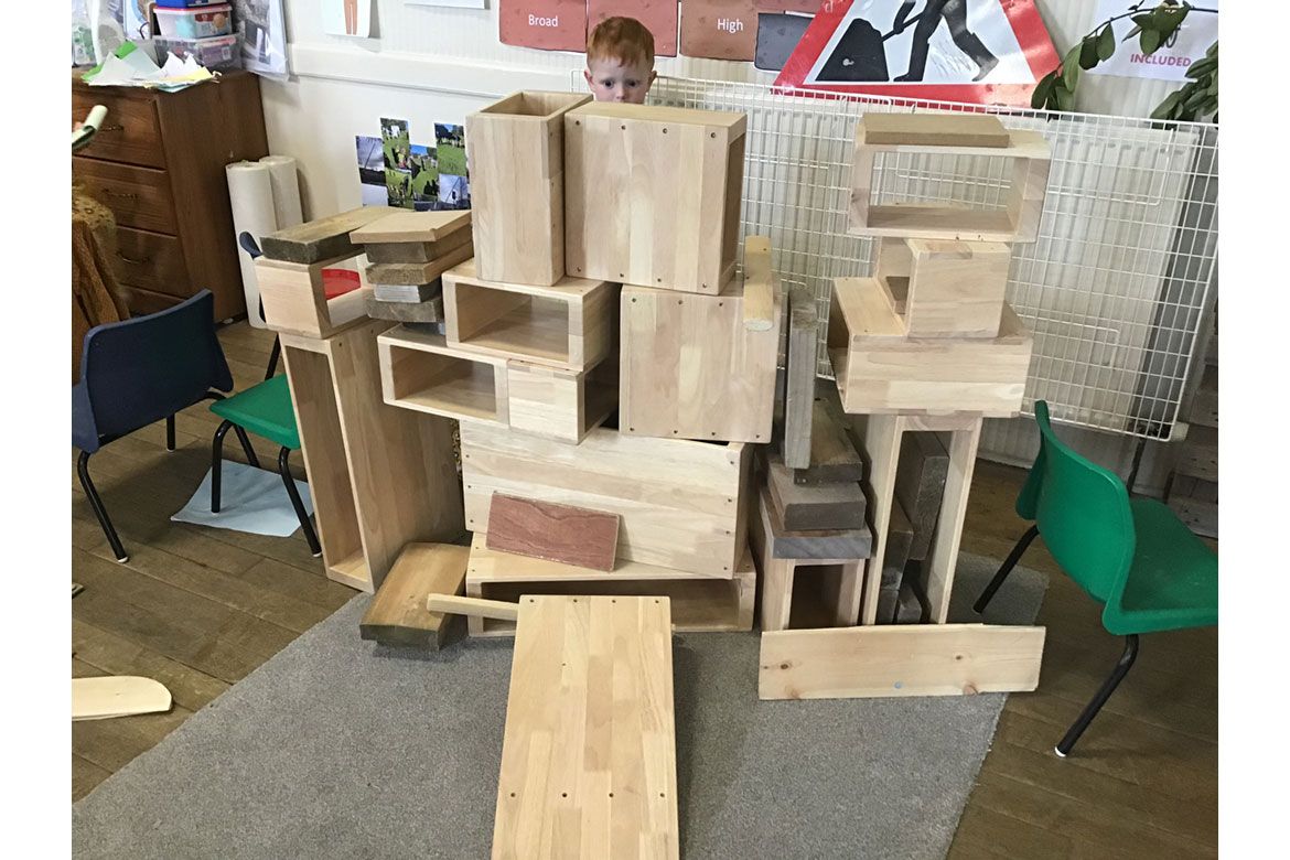 Child plays with boxes at Strathisla Children's Centre