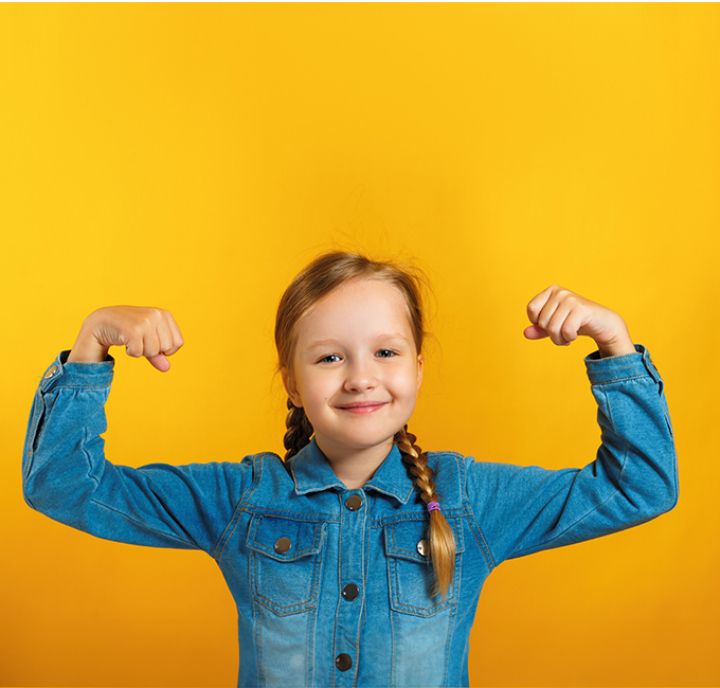 Young girl with arms raised