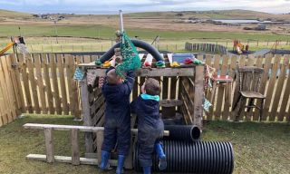Children play outdoors at a Shetland Islands ELC setting