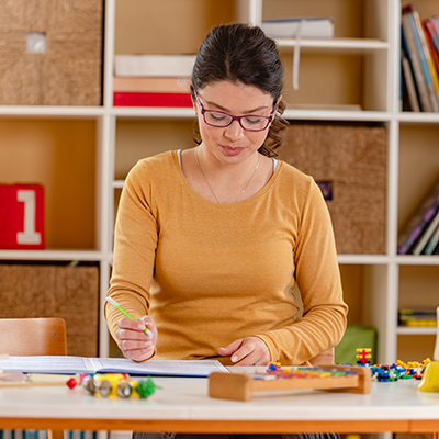 A nursery teacher writing a lesson plan